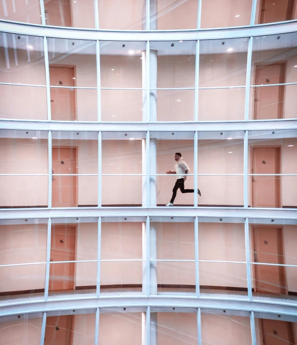 a person on a ledge suspended by multiple metal bars