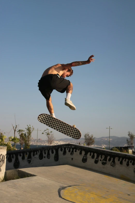 a young man in the air on top of a skateboard