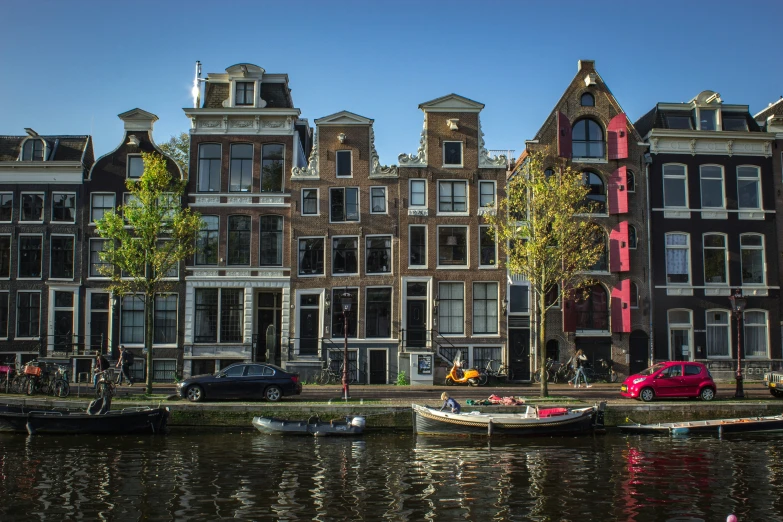 the houses are brick and two boats are parked in the water