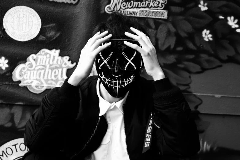 a person has a mask on that is painted black and white