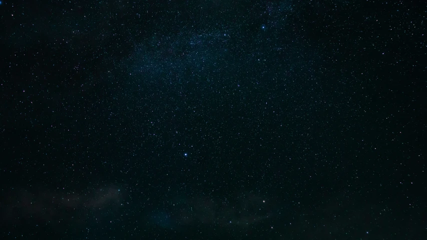 a small group of people under a sky with stars