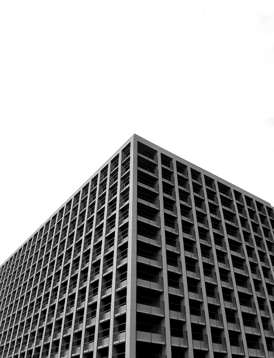 a tall black building stands near a white background