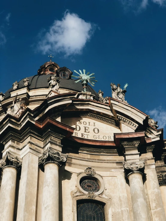 a church with two green clocks and pillars