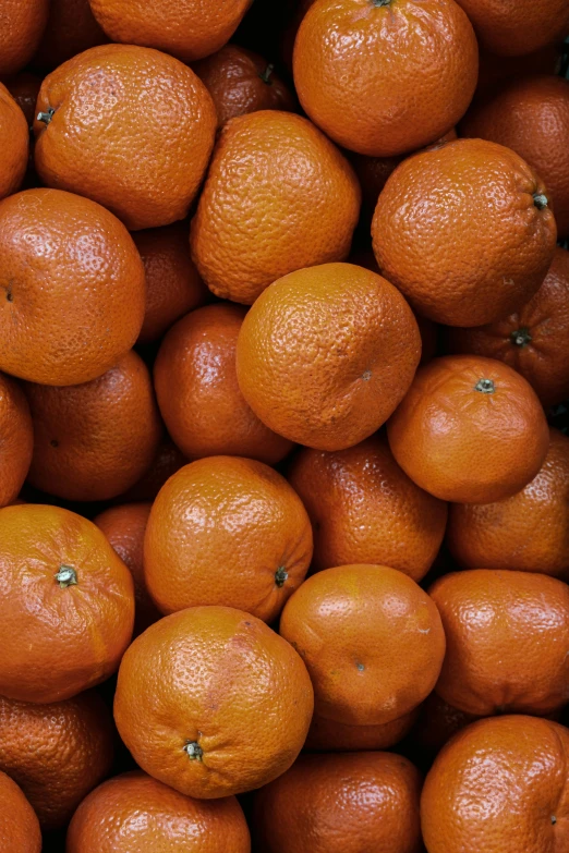 large pile of oranges sitting next to each other