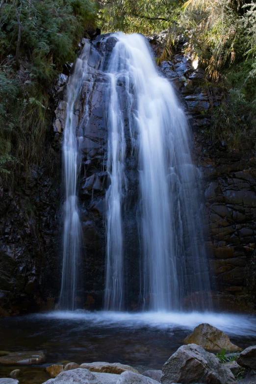 a waterfall that is falling into the water