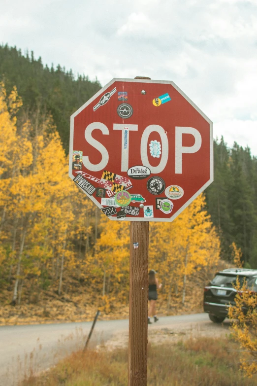 the stop sign has many stickers on it