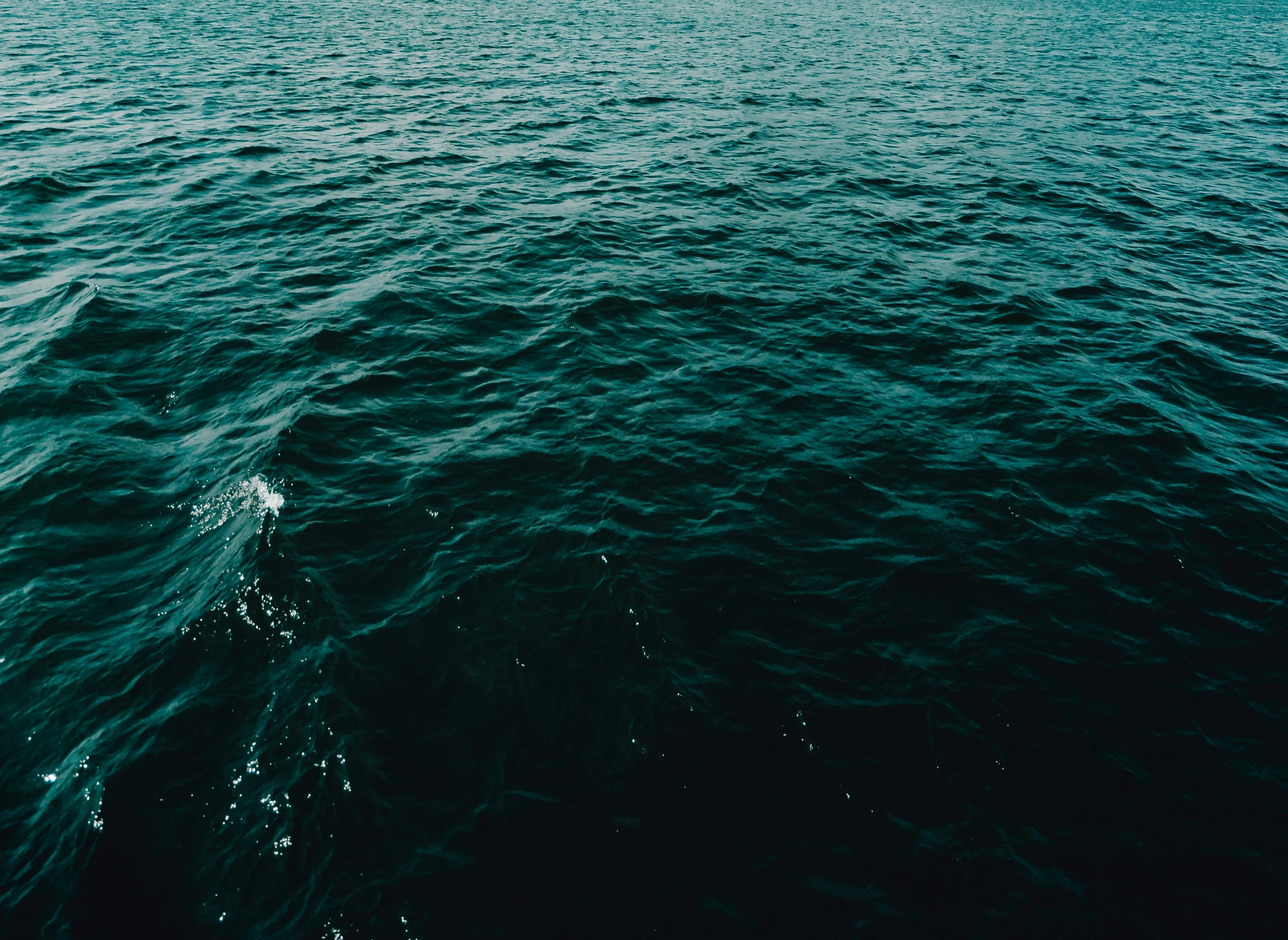 a boat in the ocean with lots of water