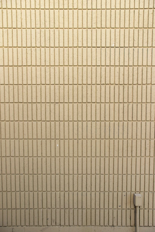 a red fire hydrant sitting next to a white tiled wall