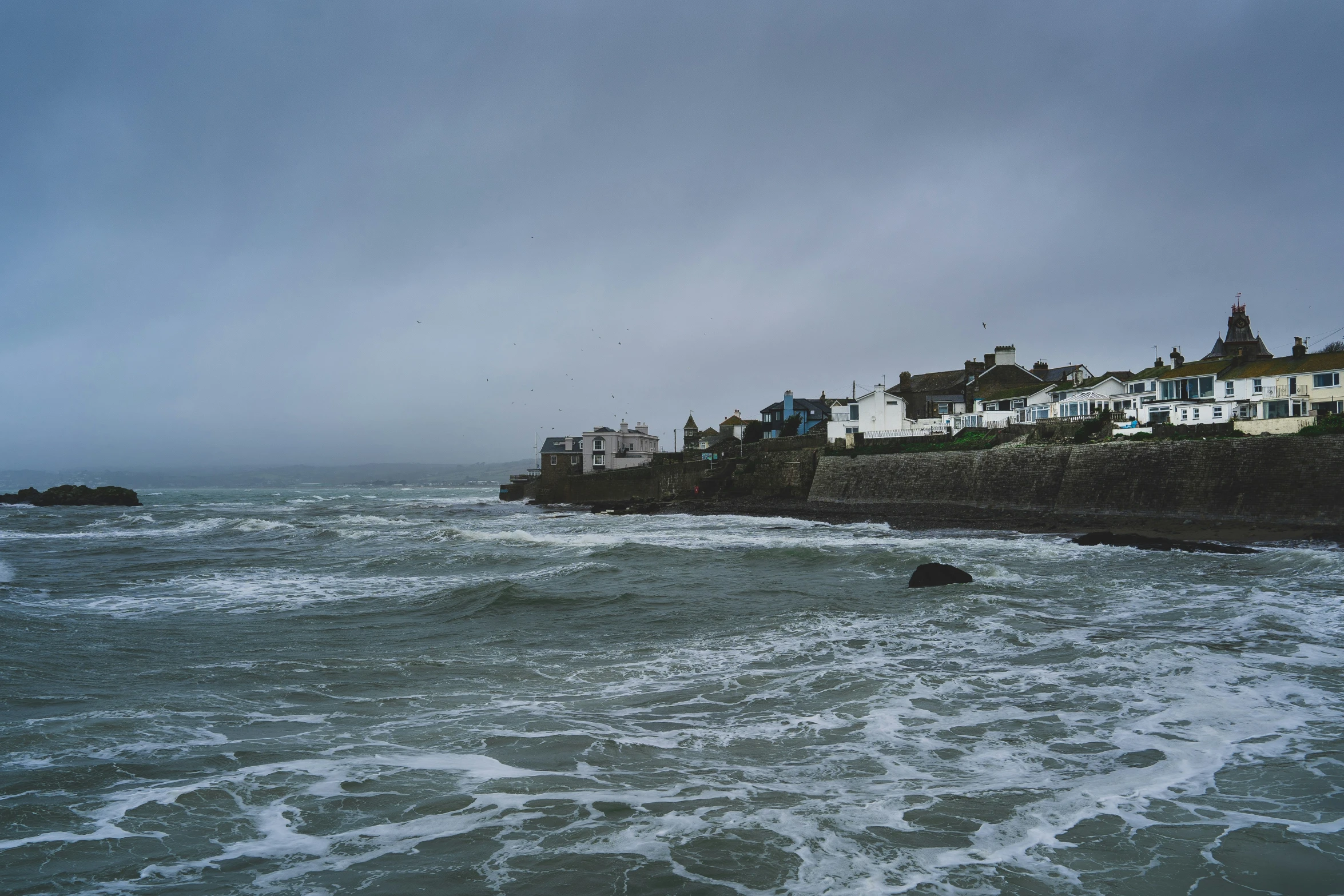 a view of houses on a beach in the ocean