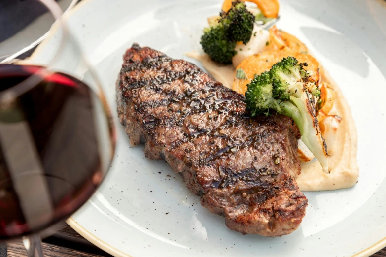 steak and vegetables are on a white plate