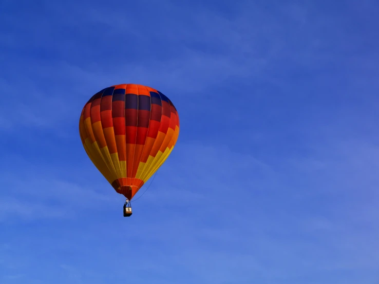 a colorful  air balloon flying through the blue sky