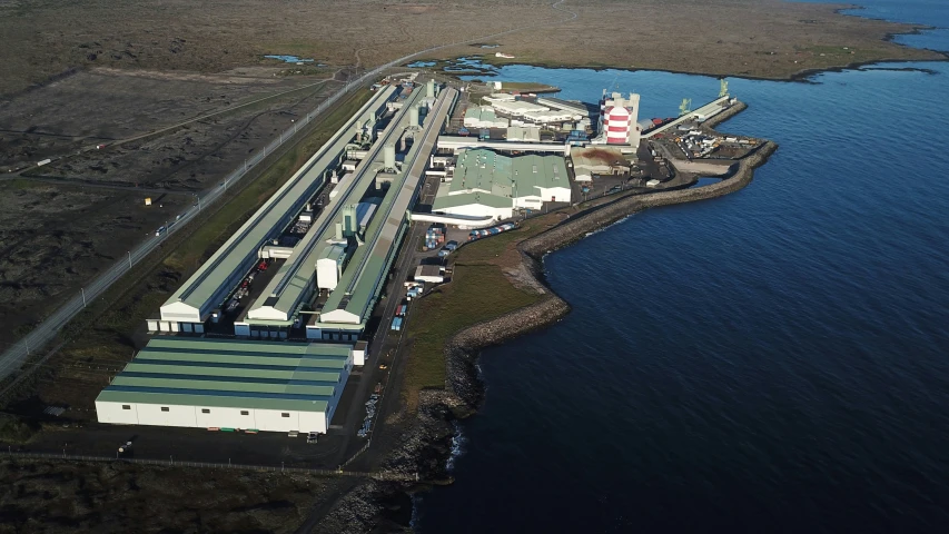 an aerial view of a large industrial plant with two power lines in the middle of it