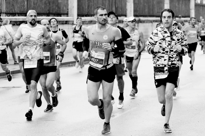 black and white po of men running a marathon