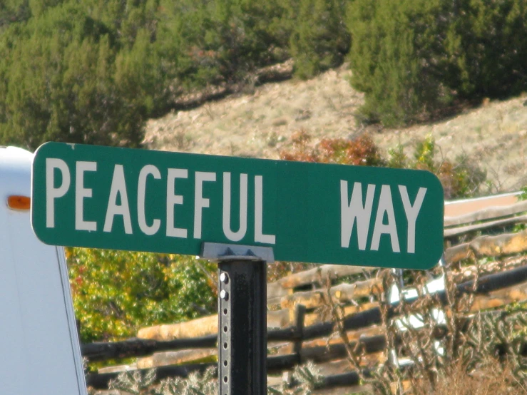 there is a street sign for peaceful way and one of the signs reads, i want you to know what