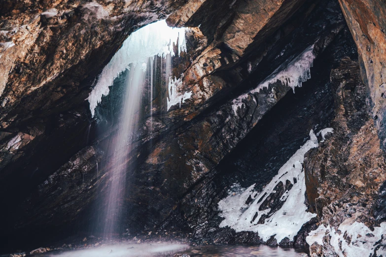 a view of a large waterfall surrounded by rocks