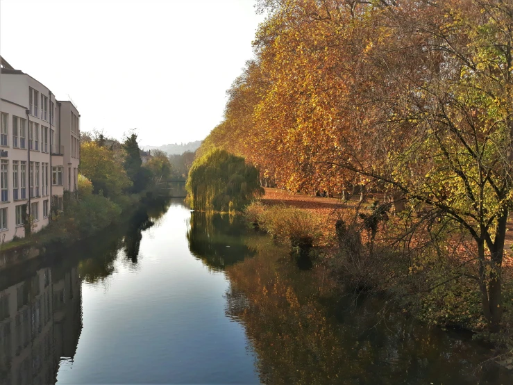 a waterway running through a neighborhood surrounded by apartment buildings