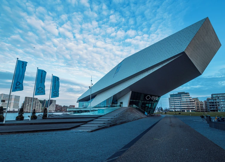 an architectural building has many blue flags in it