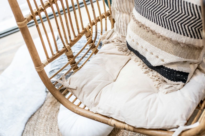 a white and black cushion a brown chair