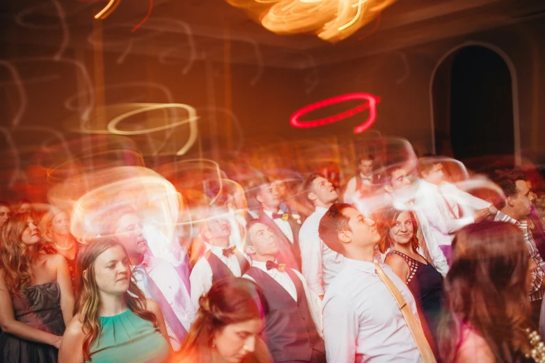 a group of people dance together at an event