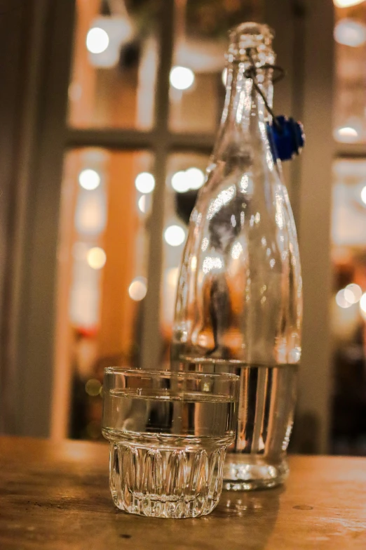 two glass goblets on a wooden table in a restaurant