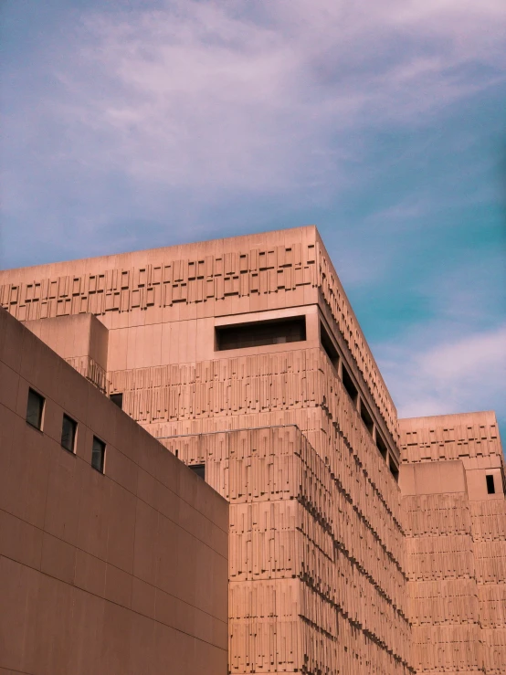 the brick walls of a building and the sky in the background