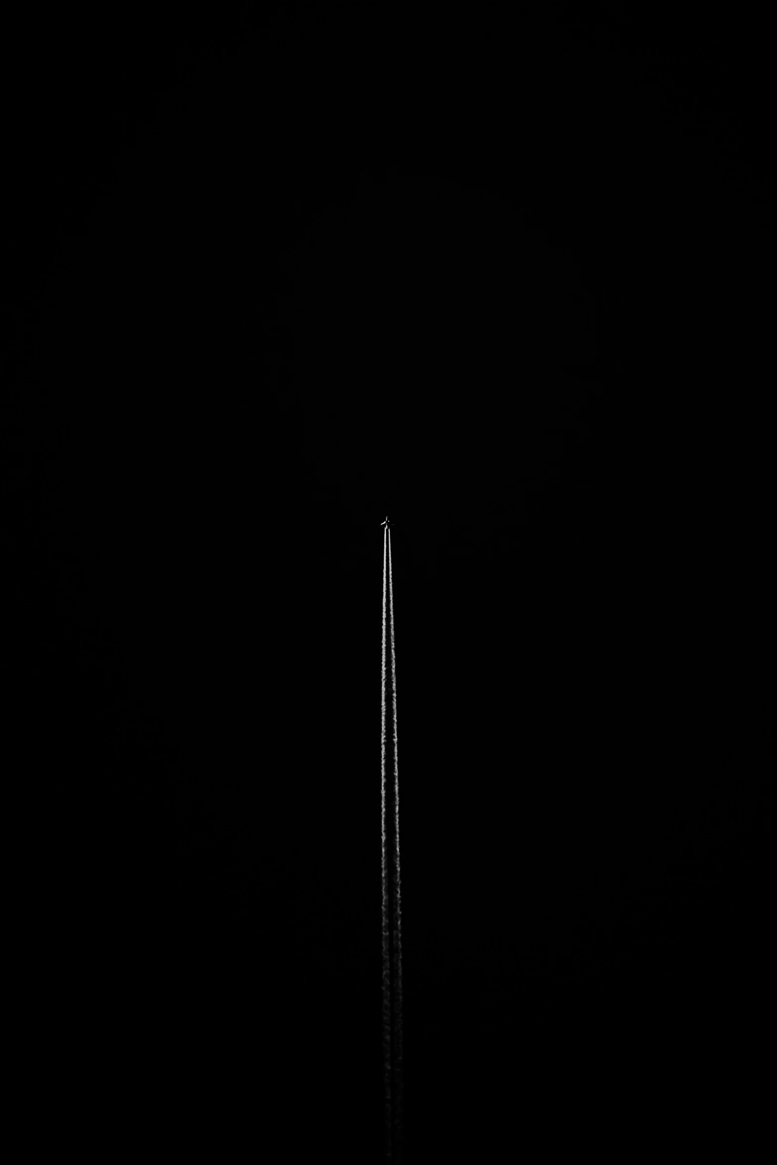 a very tall building at night on a black background