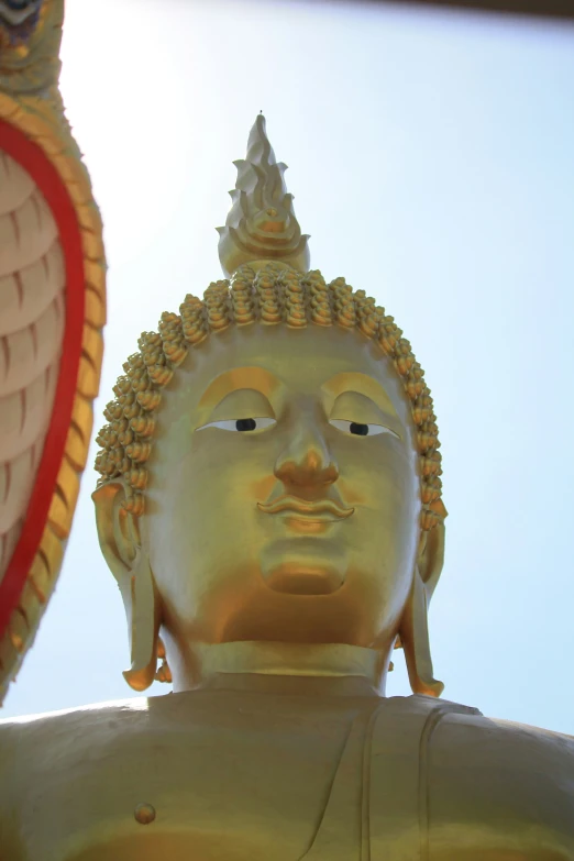 a golden statue next to a paper decoration