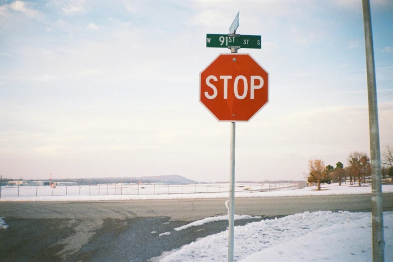 a stop sign that has street signs on top of it