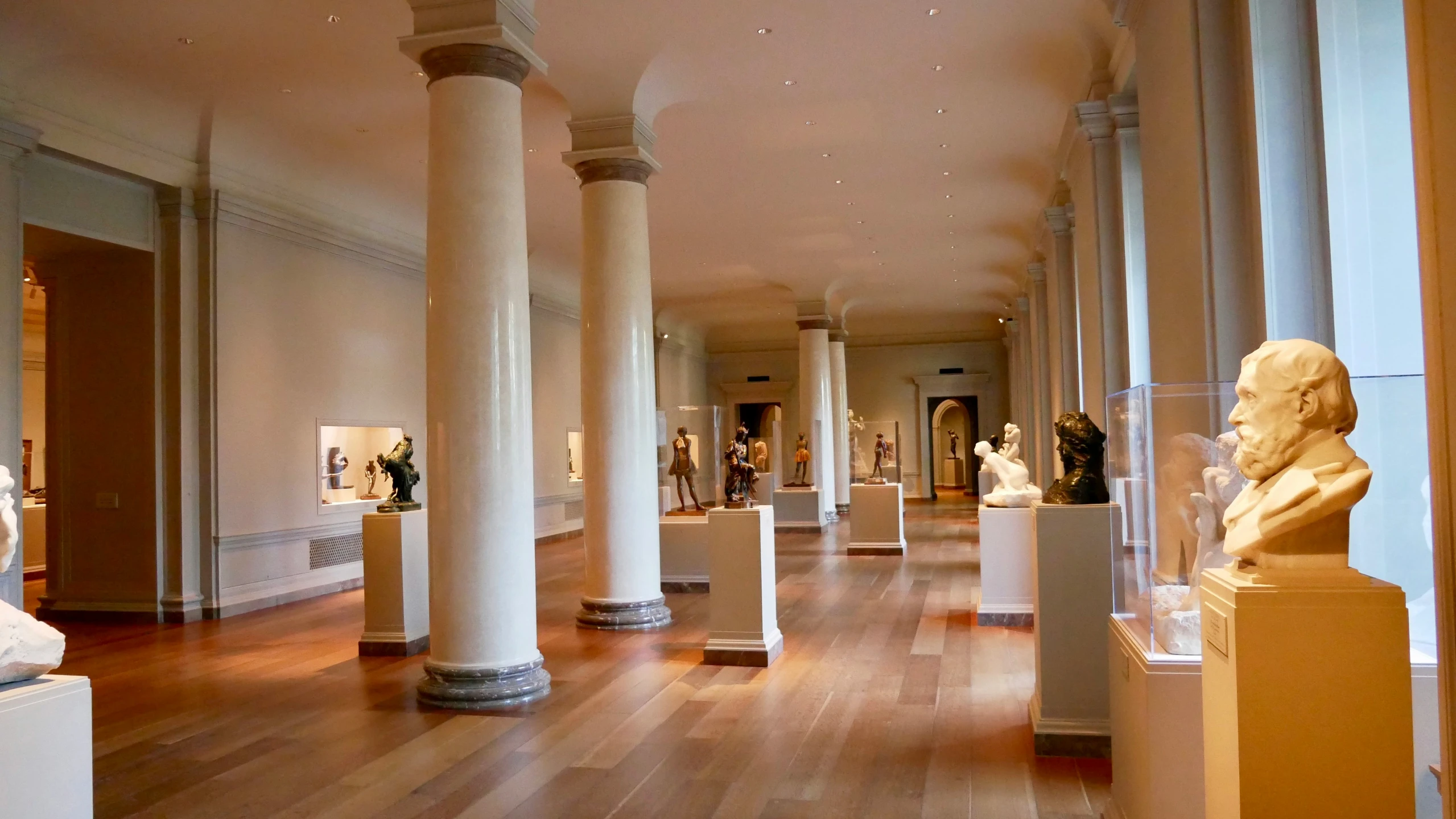 a number of statues on stands in a room