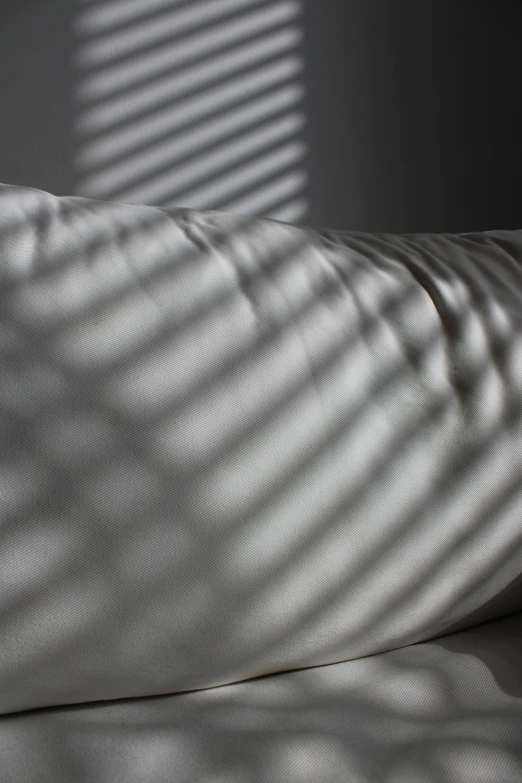 a po of a cushion made from sheets and covers that are turned into long shadows