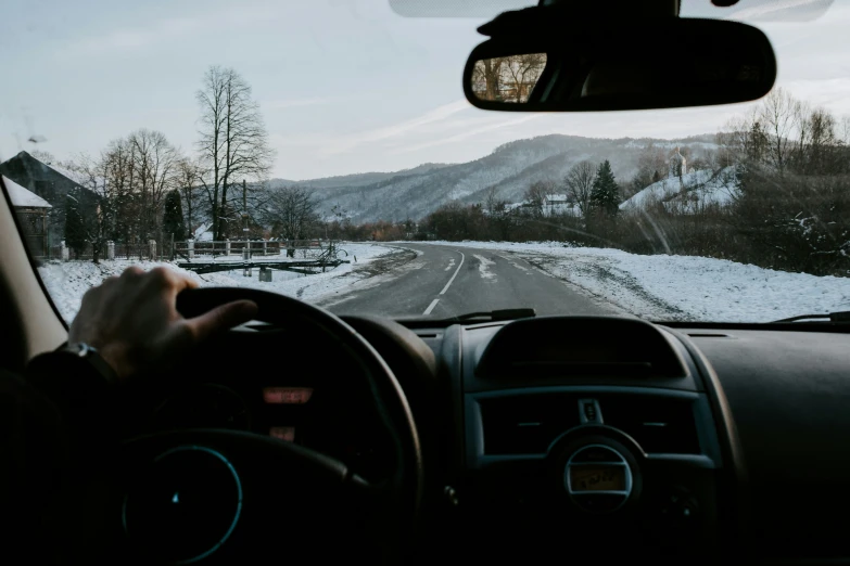 a person driving a vehicle on the snowy road