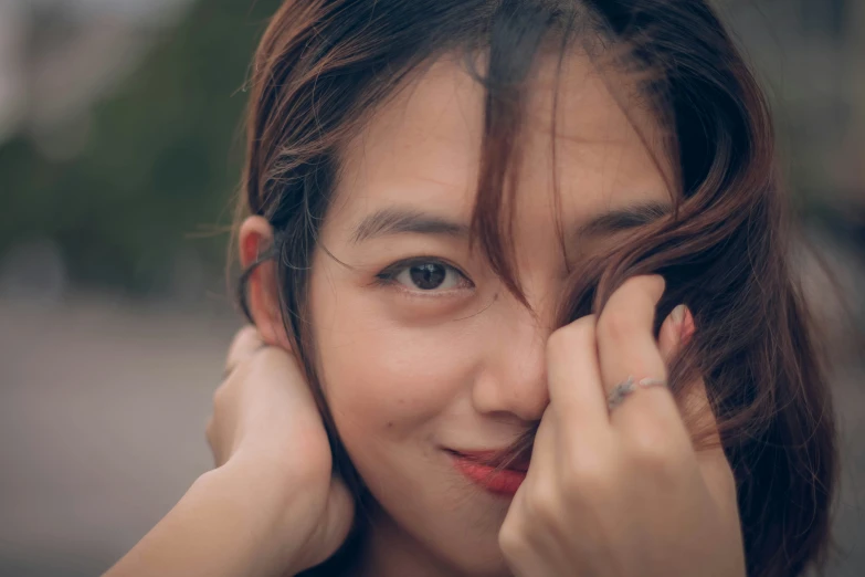 a person holds her hands near their face