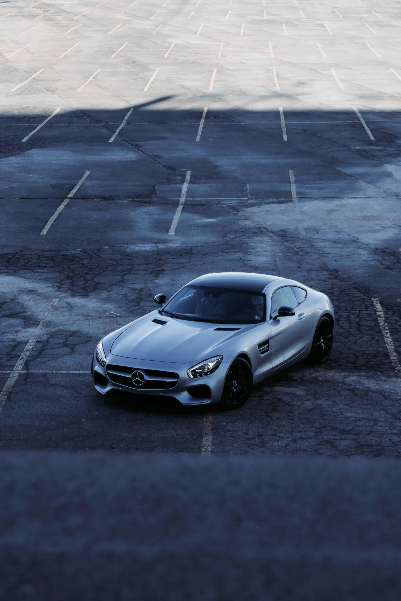 a silver mercedes sls in a parking lot