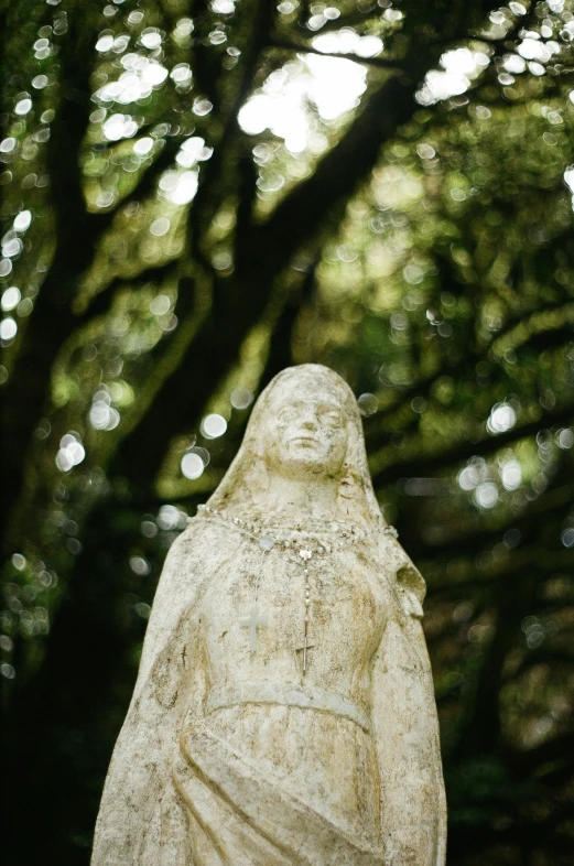 a statue of a person in the woods