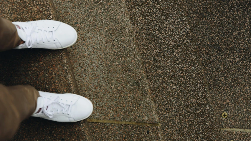 white shoes with red lining on an area in the ground