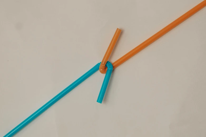 an orange and a blue toothbrush sitting on top of each other