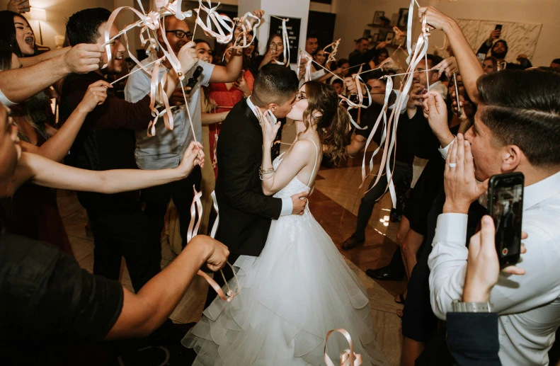 there is a bride and groom kissing in front of their guests