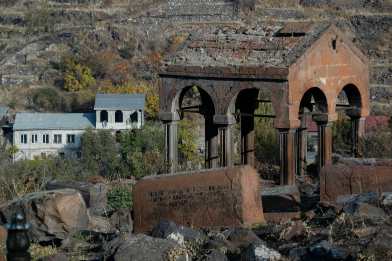 a brick building sitting on top of a rocky hillside