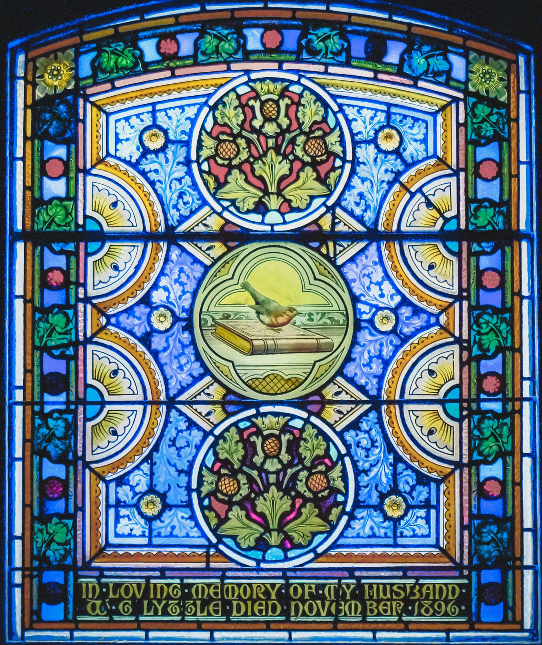 stained glass window with symbols in colorful, ornate style