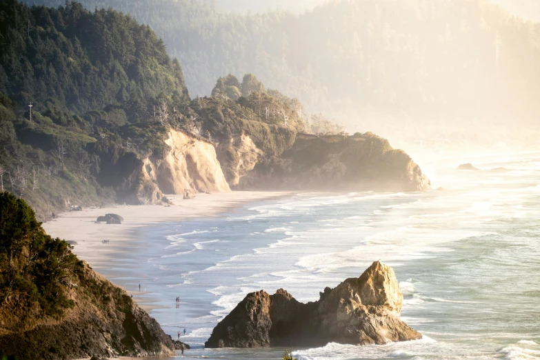 a surfer is going into the water by some rocks