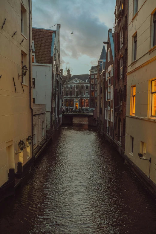 water running down a narrow canal in a city