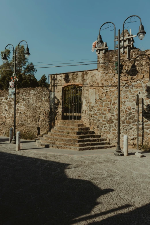 a large wall with lots of light poles around it