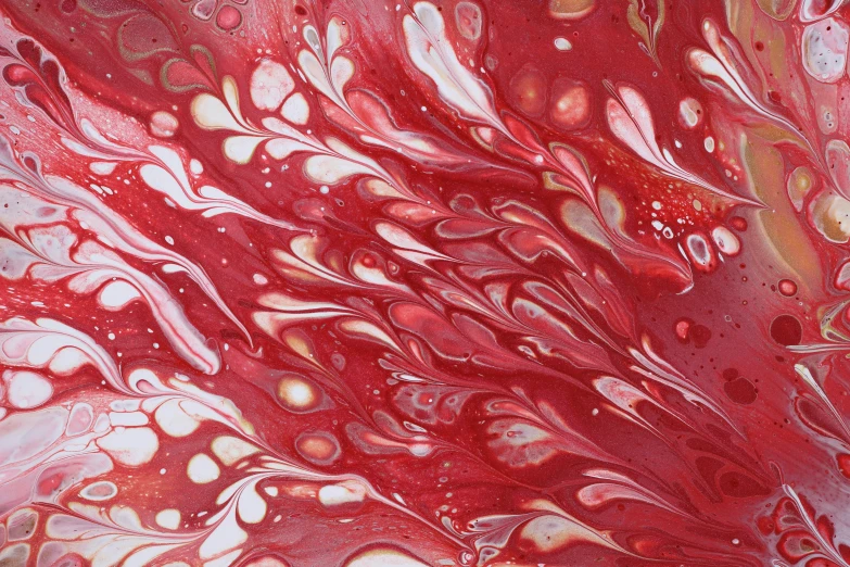 a red painting with white drops on it