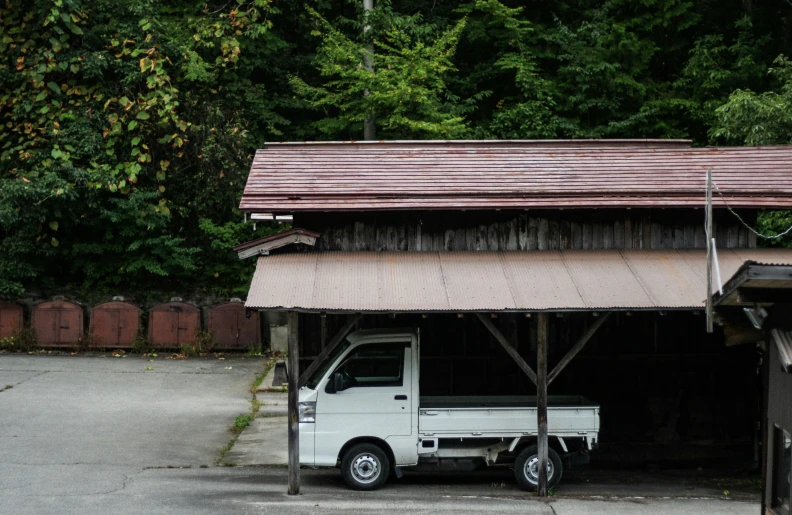 a truck parked in front of a shed