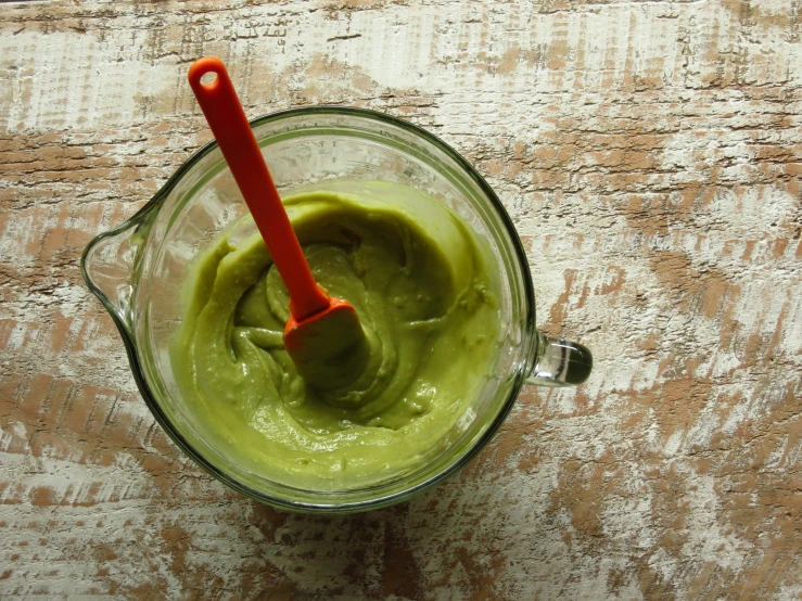 the smoothie is made with a green substance in it