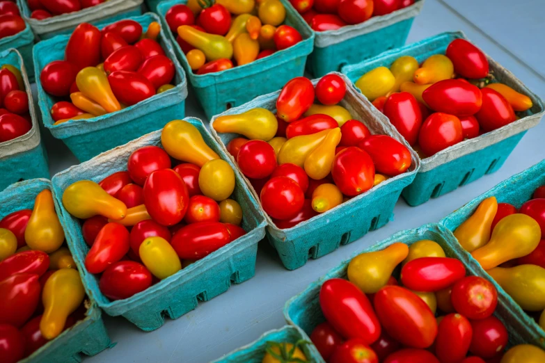 several baskets full of different colored bell peppers