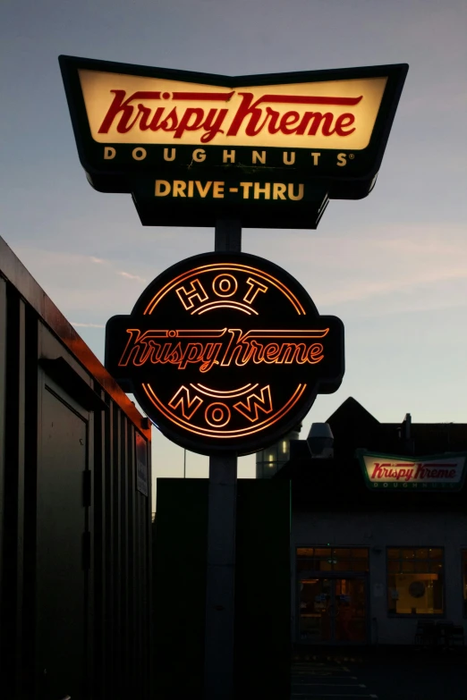 a large neon sign that is sitting on the side of a building