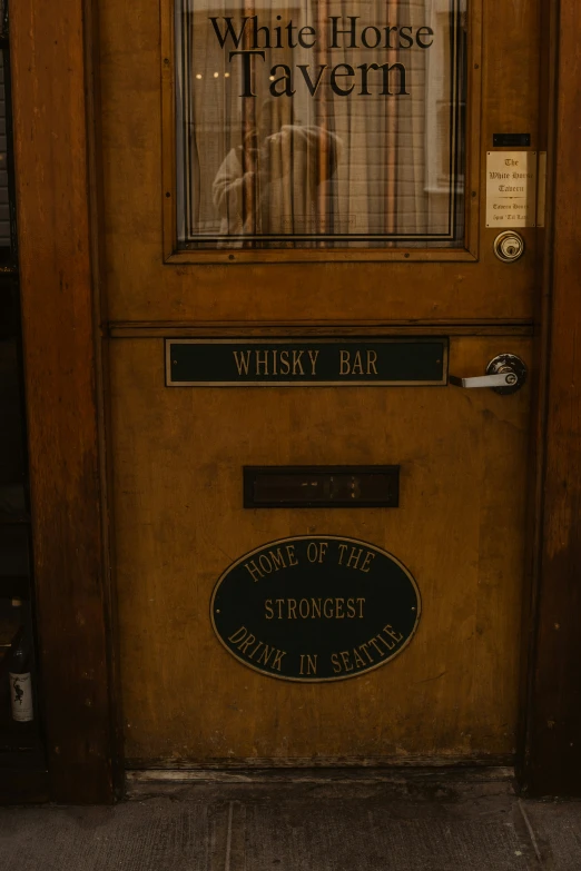 a door with sign that reads whiskey bar