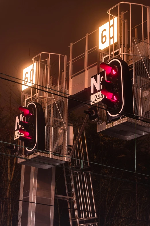 a set of stoplights hang from the metal poles