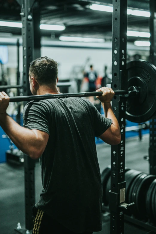 man with barbells working at the same location